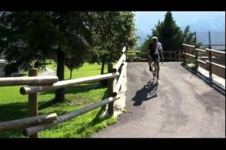 a man riding a bike on a path near a fence at Casa chanoux in Chambave