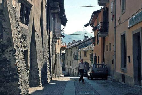 a man walking down a street in an alley at Casa chanoux in Chambave