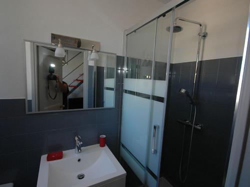 a bathroom with a shower and a sink and a mirror at Maison Vauban Plus in Saint-Raphaël