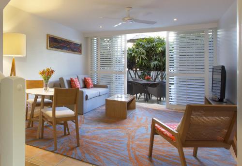 a living room with a couch and a table at Sofitel Noosa Pacific Resort in Noosa Heads
