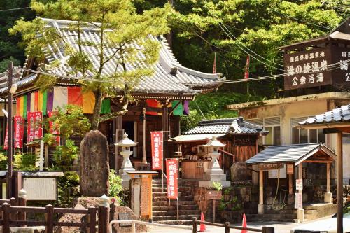 a group of buildings with signs on them at Yunominesou in Hongu