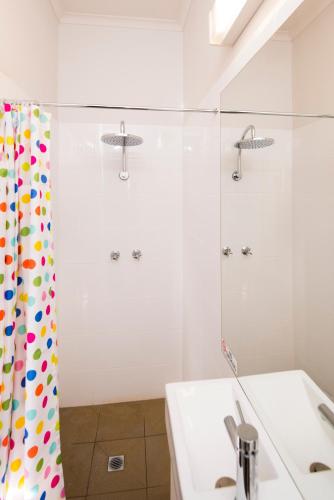 a bathroom with a shower curtain and a sink at Mowbray Hotel in Launceston