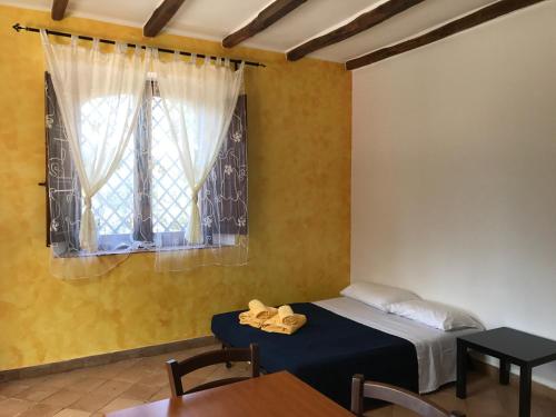 En eller flere senge i et værelse på Villa del Nespolo