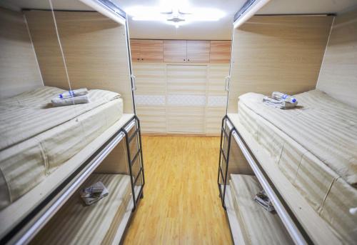 two bunk beds in a room with wooden floors at Mongolian Vision Tours in Ulaanbaatar