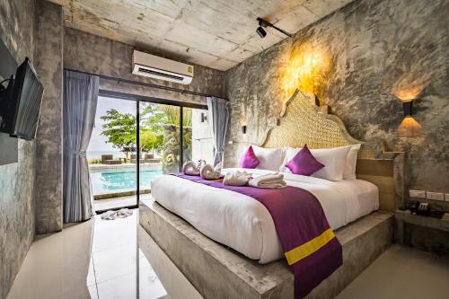 Een bed of bedden in een kamer bij Maneetel Krabi Beachfront-SHA Plus