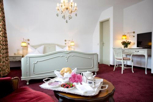 
a living room filled with furniture and decor at Hotel Traube in Stuttgart
