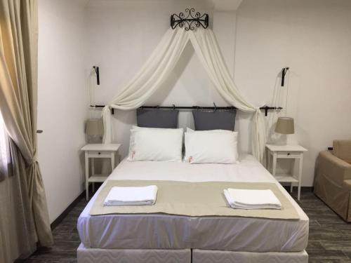 a bedroom with a bed with two towels on it at Nova Citrus Otel in Siğacık