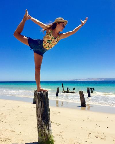 a woman standing on a wooden post on the beach at Antechamber Bay Retreats in Penneshaw