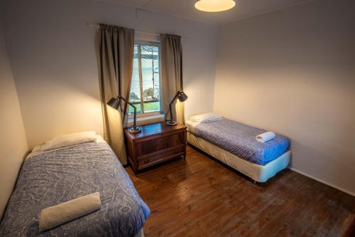 a bedroom with two beds and a window at Antechamber Bay Retreats in Penneshaw