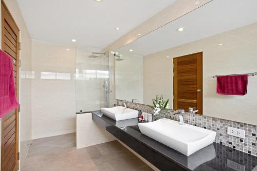 a bathroom with two sinks and a shower at Tranquil Residence 3 - 2 Bedroom Apartment in Lamai