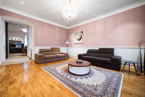 a living room with a couch and a table at Bishop Apartments in Brno