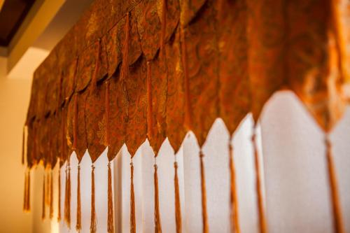a white picket fence in front of a wall at Shambaling Boutique Hotel in Kathmandu
