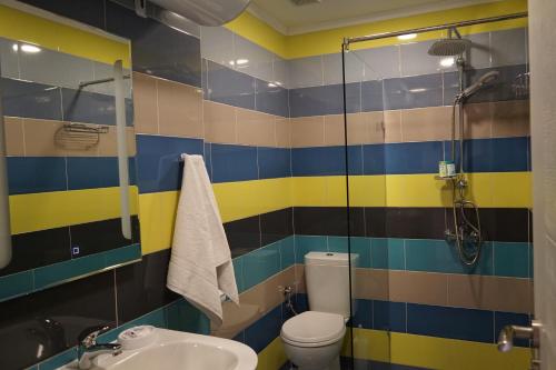 a bathroom with a shower and a toilet and a sink at Guest House Lambovi in Nesebar