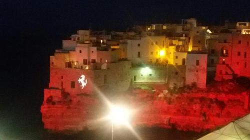 a view of a city at night with a light at Malù Bed&Breakfast in Polignano a Mare