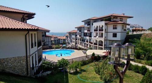 an apartment complex with a swimming pool and buildings at Apartment in Luxury Resort Sveti Vlas in Sveti Vlas