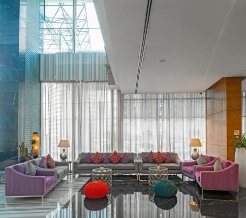 a living room filled with lots of furniture at Signature 1 Hotel Tecom in Dubai