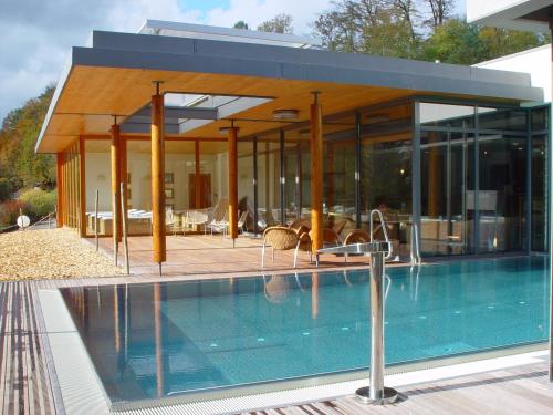 a house with a swimming pool in front of it at La Clairière bio & spahotel in La Petite-Pierre