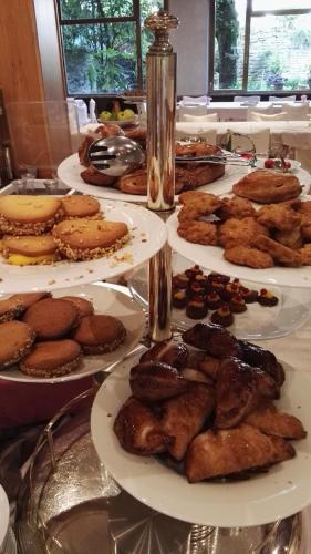 a table with plates of food on a table at Hotel Tosco Romagnolo in Bagno di Romagna