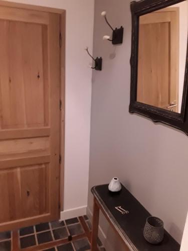 a room with a mirror and a door at Au Moulin de Valérie in Frencq