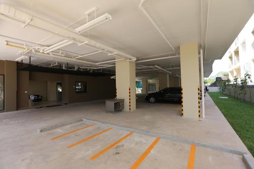 a parking garage with a car parked in it at Naka Residence in Phuket