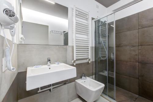 a bathroom with a sink and a mirror at Hotel Villa Augustea in Rimini