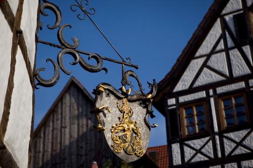 a sign hanging from a building with a building at Hotel Traube in Stuttgart