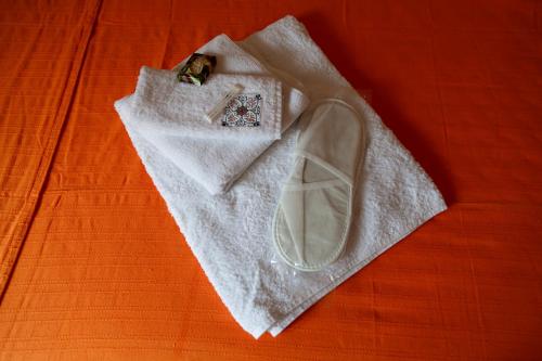 a white shoe sitting on top of a white napkin at Dalgaci Deniz Konukevi in Ayvalık