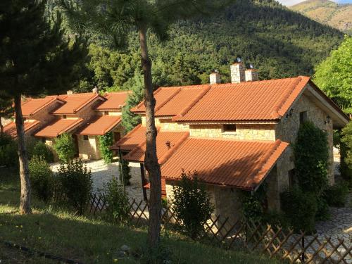 a row of houses with orange roofs at Georgio's V Chalet Kalavrita in Kalavrita