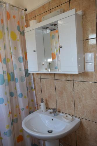 a bathroom with a sink and a medicine cabinet at White Lake Holiday House in Elafonisi