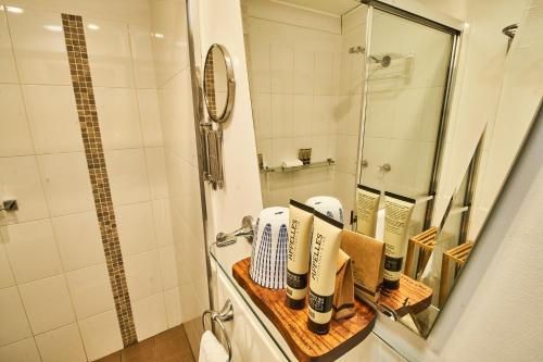 a bathroom with a sink and a shower with a mirror at The Bronte Boutique Hotel in Morpeth