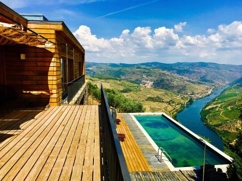 a balcony with a pool and a view of a river at Quinta de Santa Marinha in Castedo