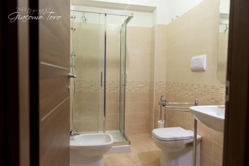 a bathroom with a shower and a toilet and a sink at Casa Sofia Vacanze A Montalbano Elicona in Montalbano Elicona