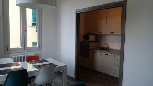 a kitchen and dining room with a table and chairs at memeapartments in Genova