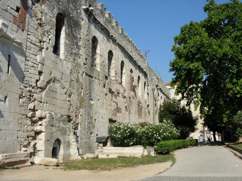 an old stone building with white flowers in front of it at Sleep Split in Split