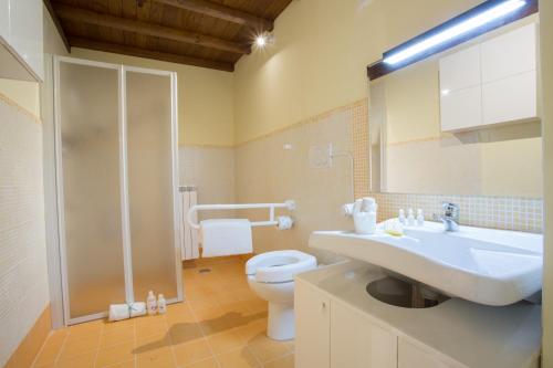 a bathroom with a sink and a toilet and a mirror at Residence Viviverde in Terni