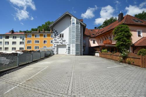 an empty parking lot in front of some buildings at Apartments Otre Frymburk in Frymburk