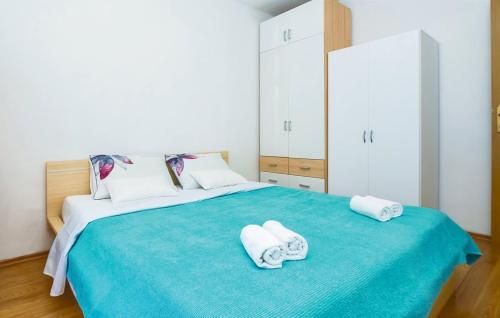 a bedroom with a large bed with towels on it at Apartment Mešin in Split
