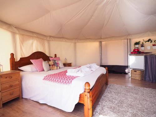 a bedroom with a bed in a tent at The Old Dairy Farm in Emsworth