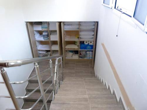 a staircase in a room with white walls at Dorvin Apartments in Dhërmi