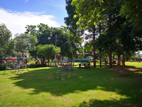 a park with a playground in the grass at Goldengold (Khaoyai) Resort & Spa in Mu Si