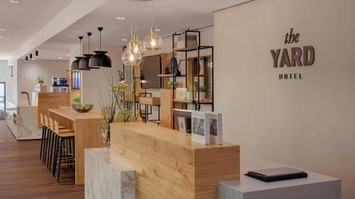 a store with wooden tables and chairs in a room at Hotel the YARD in Berlin