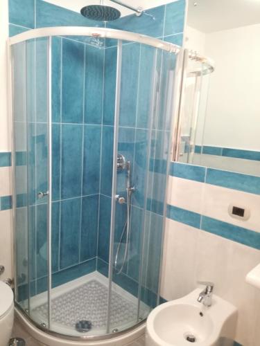 a bathroom with a shower with a toilet and a sink at B&B Stella in Vico Equense