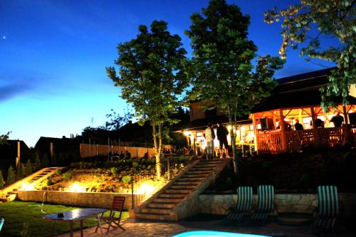 a building with stairs and lights in front of it at Mlyn Penzion & Wellness in Radvaň nad Dunajom