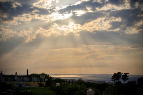 a view of the ocean under a cloudy sky at Abbaidda Hotel in Valledoria