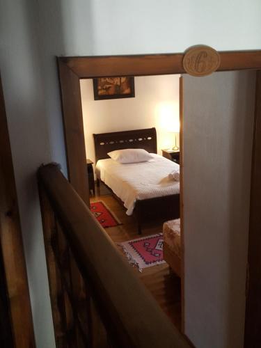 a view of a bedroom with a bed and a mirror at Hotel Gjirokastra in Gjirokastër