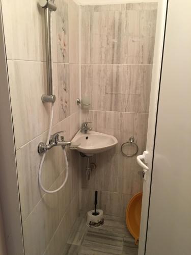 a bathroom with a sink and a shower at Kapka Apartments in Kiten