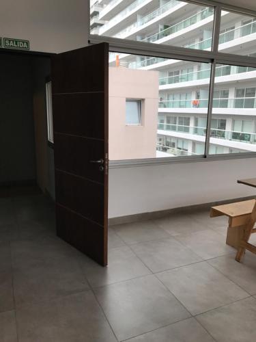 a room with a large window and a black cabinet at Olivos Suites in Olivos