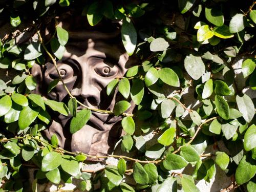 a statue of a gorilla hiding in a tree at sopra al FORTE in Querceta