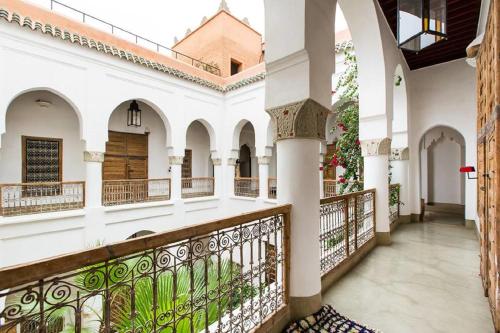 a corridor of a building with a balcony at Riad Matham in Marrakesh