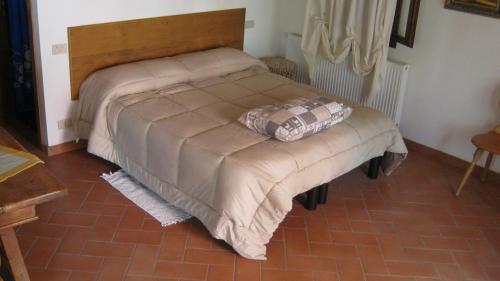 a bed in a bedroom with a pillow on it at La Residence da Caterina in Vittorio Veneto